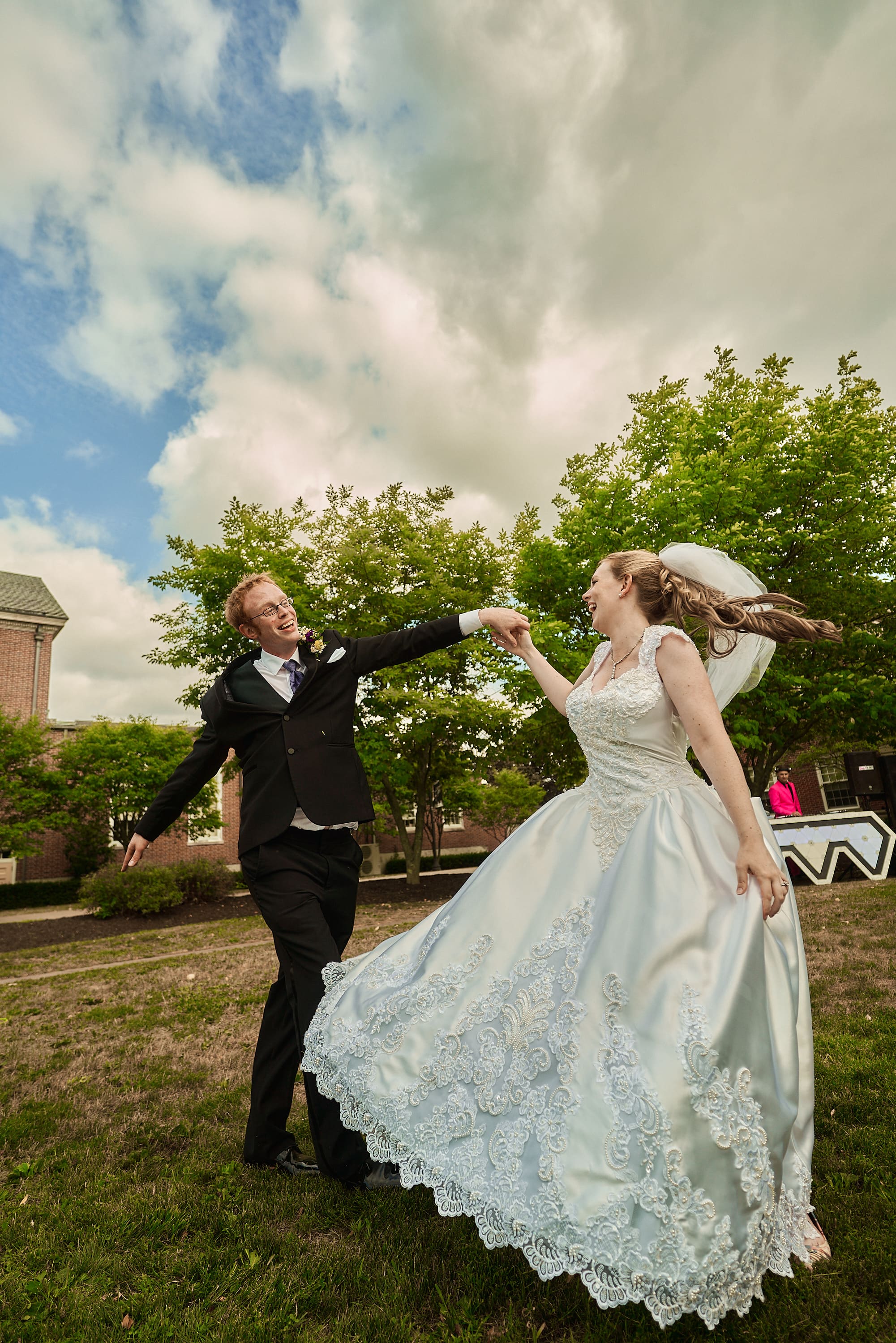 Cinematic wedding portrait of a couple walking through a green park